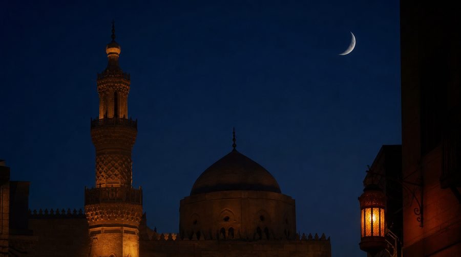 Historic Cairo mosque under a crescent moon